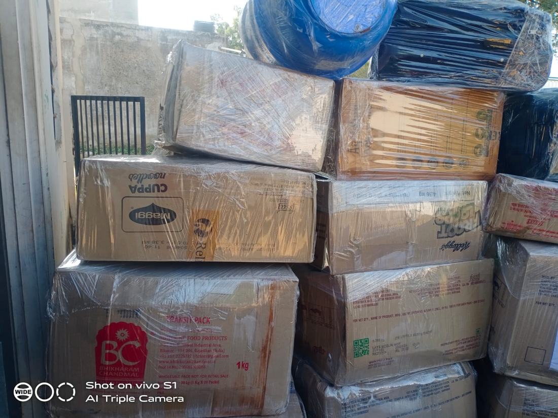 Stacked and shrink-wrapped cargo cartons staged for loading